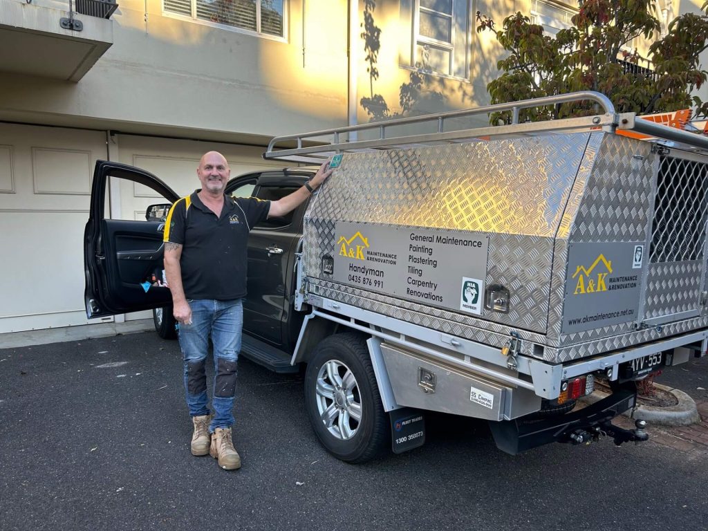 Andy Morgione standing next to work ute